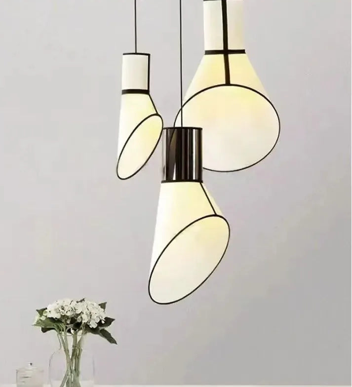 Modern pendant lights with white and black design on a neutral background