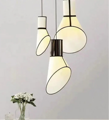 Modern pendant lights with white and black design on a neutral background