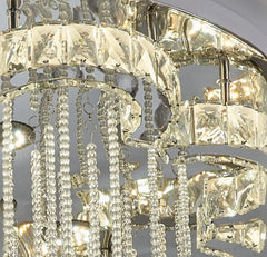 Crystal chandelier with clear and gold accents on a gray background