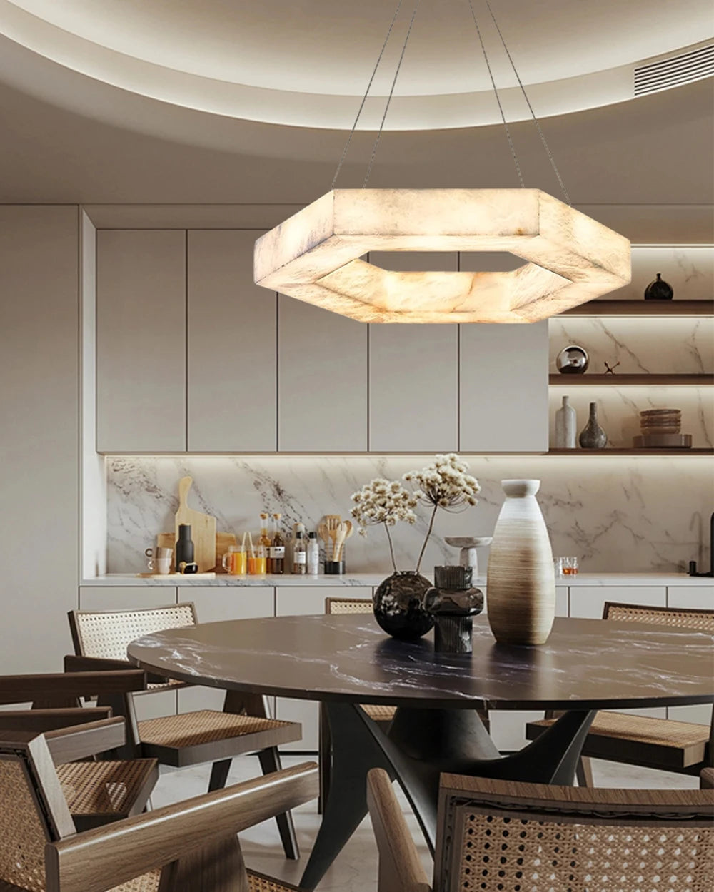 Modern kitchen with a round dining table and pendant light fixture.