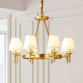 Polished copper ring chandelier with six white fabric drum shades, mounted on a white ceiling.
