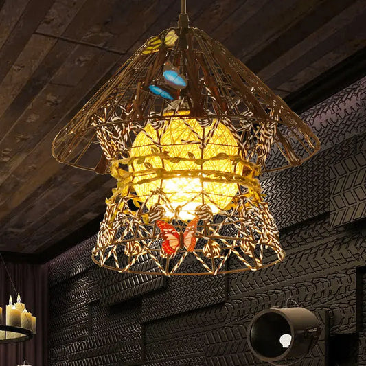 Close-up of a conical, woven rattan pendant light with intricate brown and white weaving, adorned with colorful butterfly decorations and a glowing warm yellow light source inside.