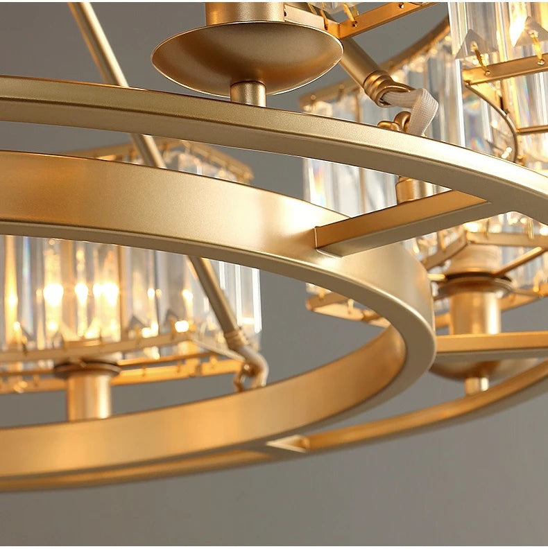 Gold chandelier with clear glass shades on a gray background