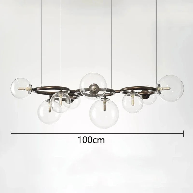 Modern chandelier with six glass bulbs on a white background, featuring measurement text.