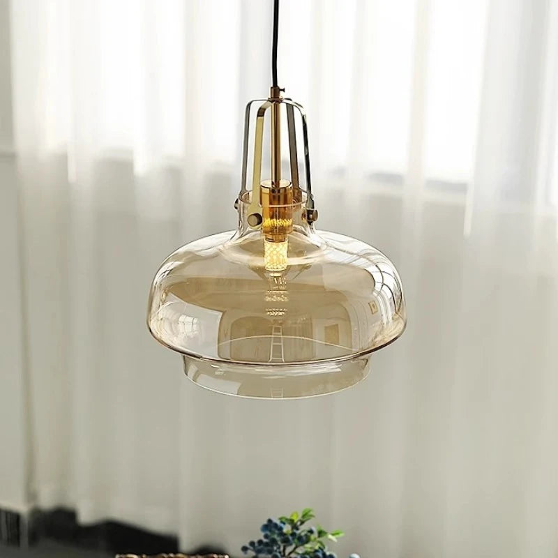 Pendant light with amber glass shade in a softly lit room