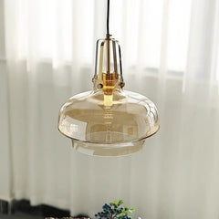 Pendant light with amber glass shade in a softly lit room