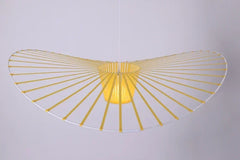 Yellow ceiling light fixture with fan-like design on a gray background