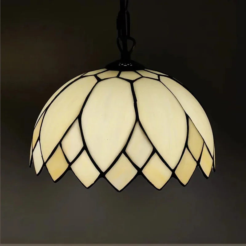 Cream colored dome-shaped Tiffany style stained glass pendant light with black leading