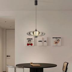 Modern pendant light hanging above a round table with 'Astro Boy' posters on the wall.