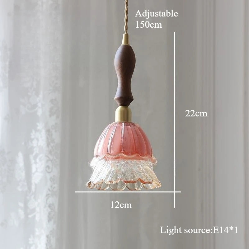 Decorative pendant light with measurements on a plain background