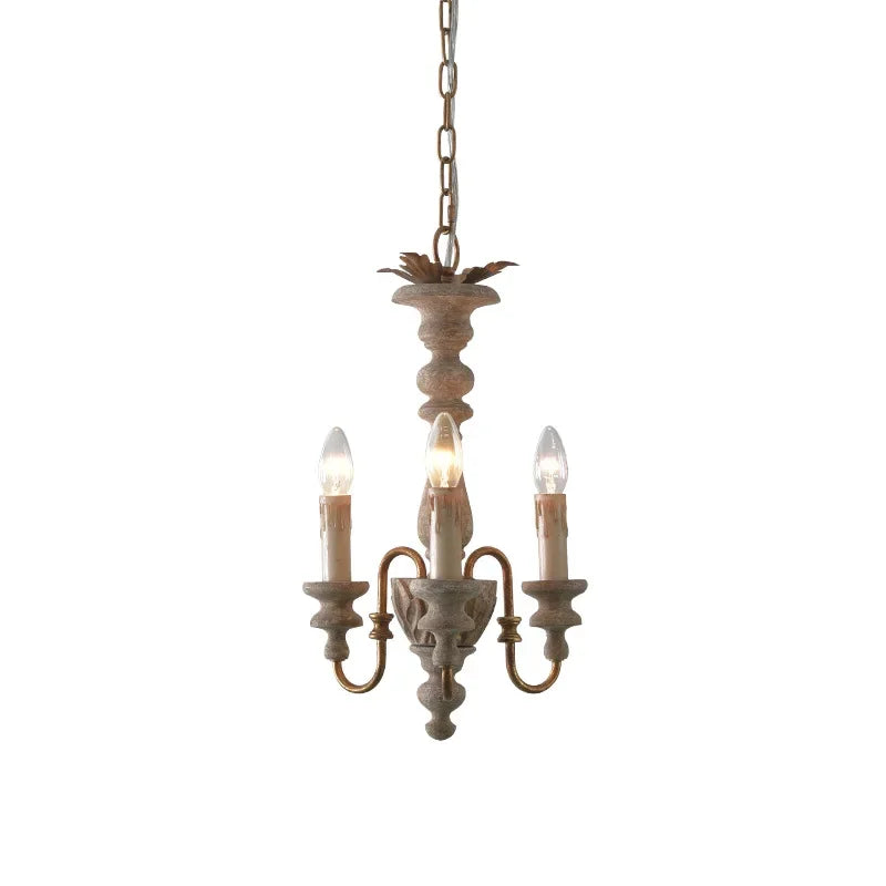 A standalone view of a distressed wood candelabra pendant light with three light sockets against a clean white background.