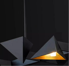 Geometric pendant lights with crystal glass material on a dark background