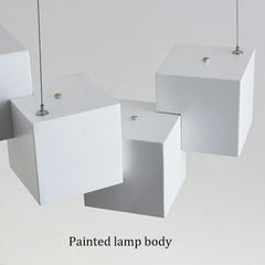 Two white pendant lamps hanging from the ceiling with a plain background.