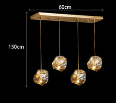 Gold pendant light fixture with crystal-like shades, shown with dimensions on a black background.