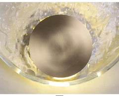 Decorative wall light fixture with gold sphere and glass casing