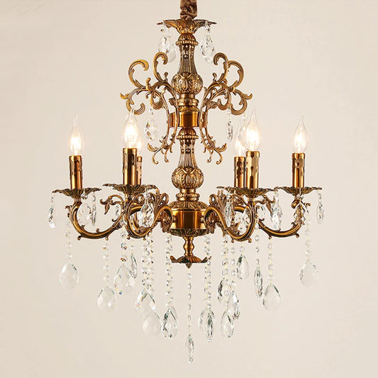Close-up of a coppery multi-arm chandelier with clear crystal droplets and candle-style lights against a white background.
