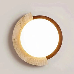 Detail shot of the natural stone and dark metallic rim of an oval LED flush mount ceiling light.