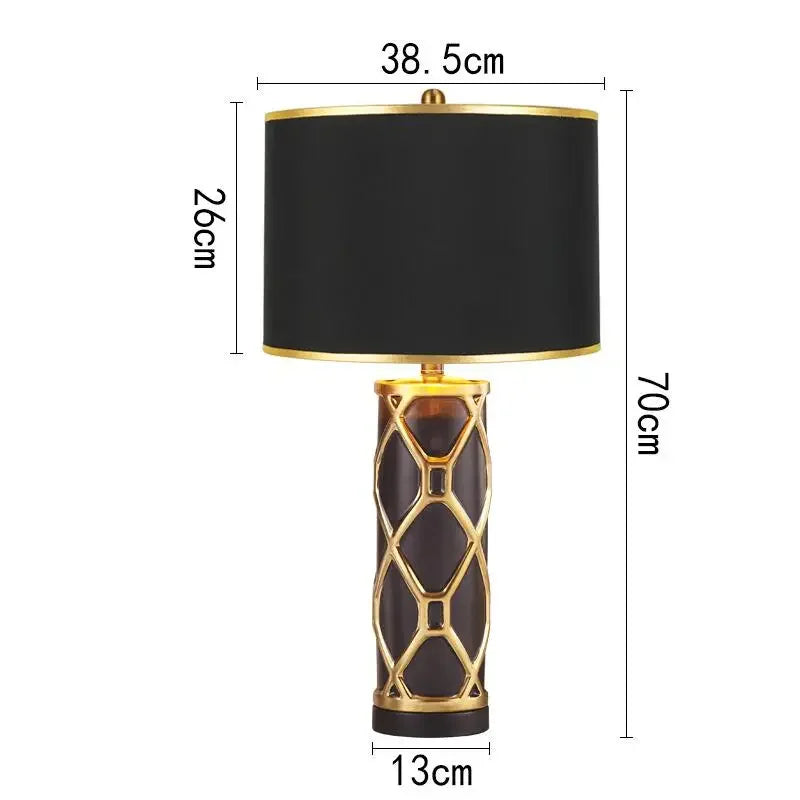 Black and gold lamp with dimensions indicated on a white background