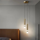Gold cylindrical pendant light with a white light strip at the bottom, hanging from a gold ceiling mount.
