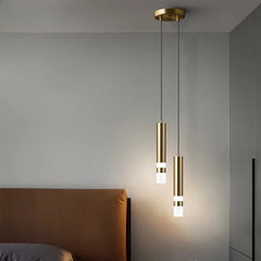 Gold cylindrical pendant light with a white light strip at the bottom, hanging from a gold ceiling mount.