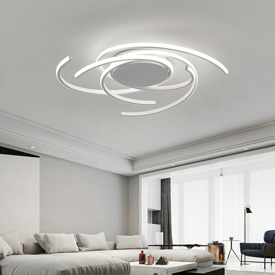 White spiral swirl flush mount LED ceiling light fixture mounted on a white ceiling in a living room.