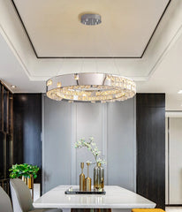 Modern chandelier hanging above a dining table in a stylish room.