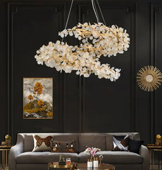 Luxury chandelier hanging above a gray sofa in a stylish living room.