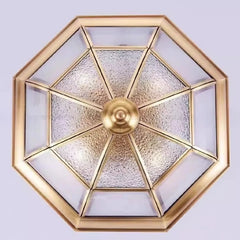 Decorative ceiling light fixture with gold frame and glass panels on a white background