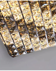 Close-up of a decorative wall light fixture with crystal-like design on a gray background