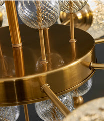 Gold chandelier with glass shades on a dark background