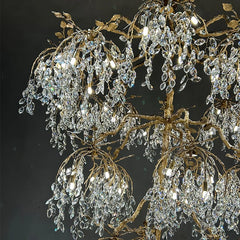 Luxurious crystal chandelier with gold branches against a dark background