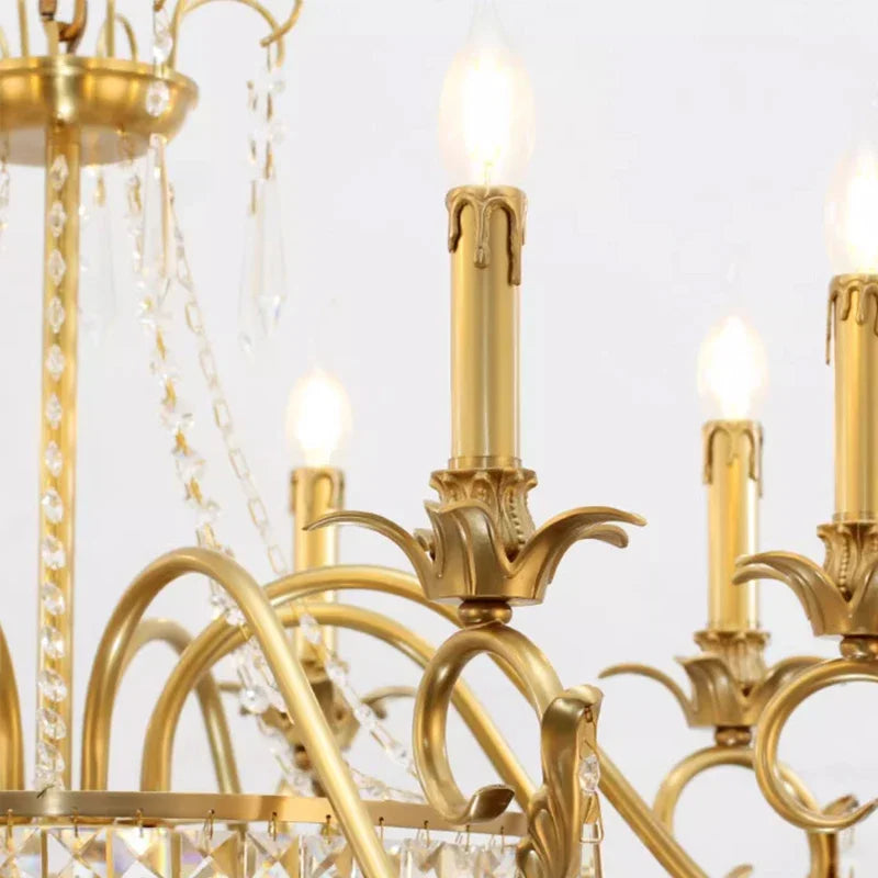 Close-up of the brass candle-style bulb holders and crystal accents on the chandelier.