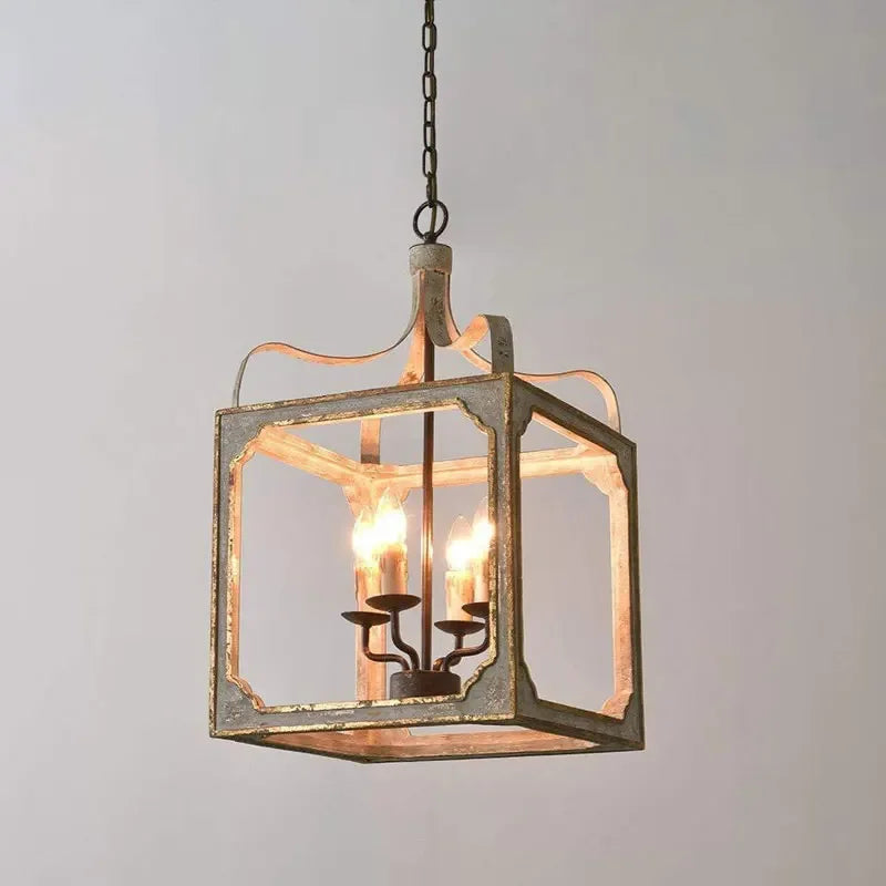 Close-up view of the distressed gray and gold finish on the lantern chandelier frame.