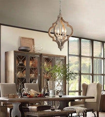 Dining room with wooden table, chairs, and a large window.