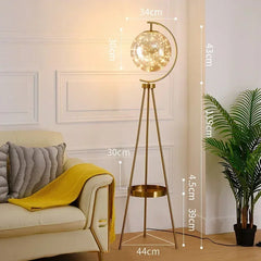 Gold floor lamp with measurements in a living room setting