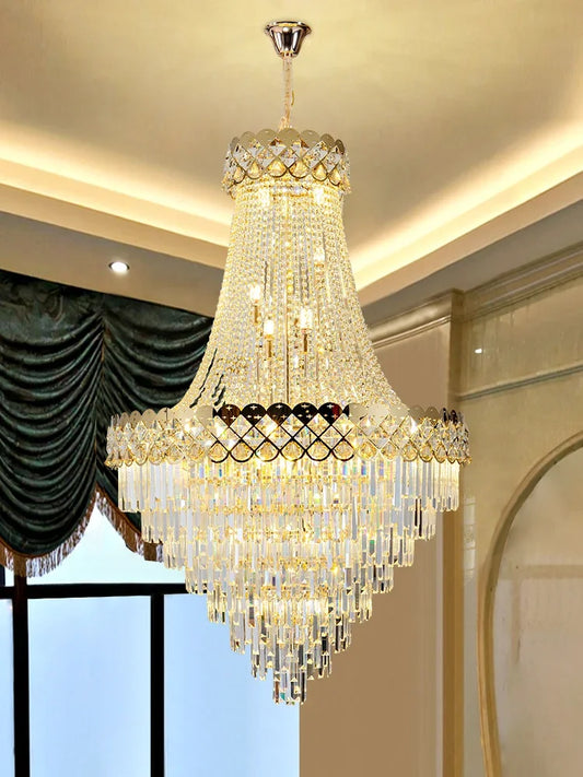 Close-up view of the gold frame and crystal droplets on a cascading chandelier, showcasing intricate details.