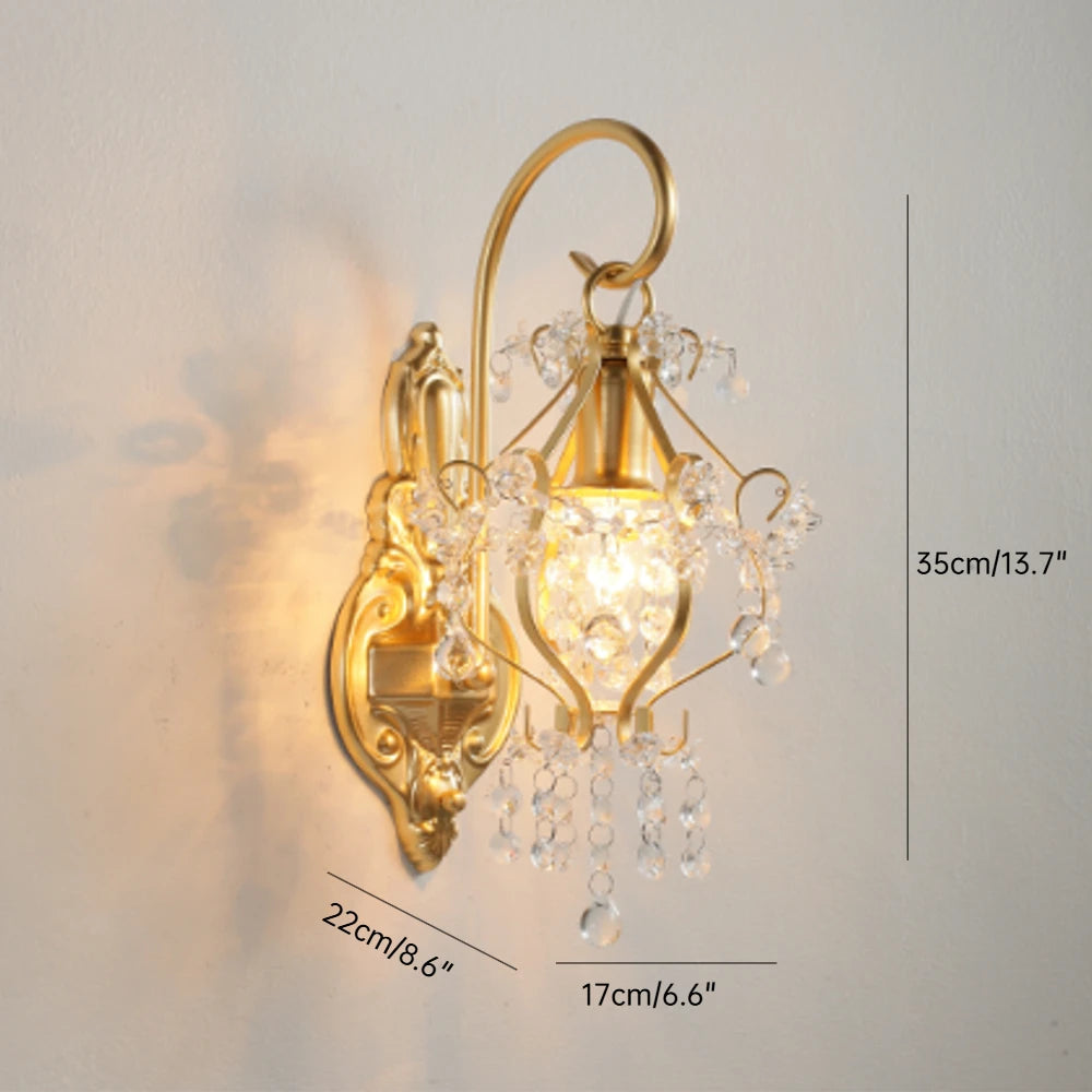 Gold wall sconce with crystal accents on a light gray background