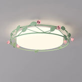 A green metal flush mount ceiling light decorated with pink roses and green leaves, illuminating a room.