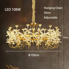 Gold chandelier with leaf-like design on a dark background, featuring dimensions and LED wattage.
