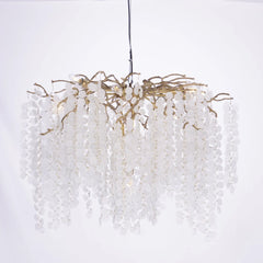 Chandelier with white beads and gold accents on a white background