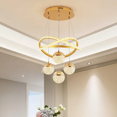 Modern gold chandelier hanging in a room with floral decor.