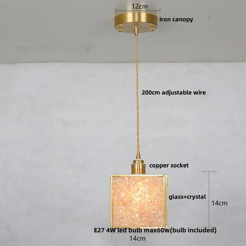 Gold pendant light with labeled parts on a white background