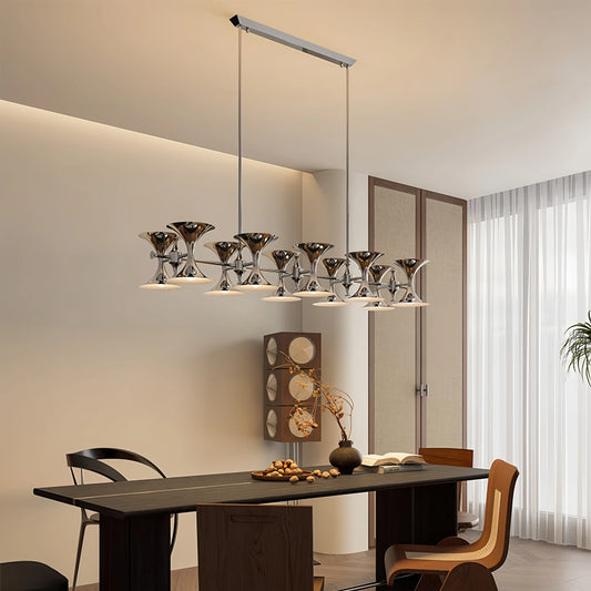 Chrome cluster chandelier with horn-shaped shades hanging over a dining table