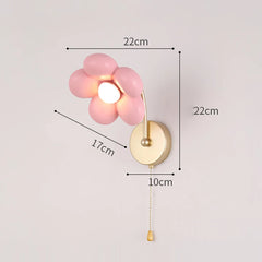 Wall lamp with pink floral design and gold fixture, showing dimensions on a light gray background.