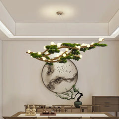 A branch-shaped chandelier with multiple small LED bulbs, resembling a natural tree branch adorned with green foliage, suspended from the ceiling in a modern dining room.