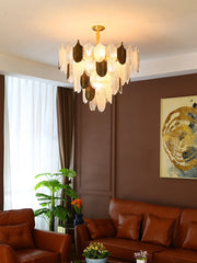 Living room with a chandelier, brown sofa, and decorative elements.
