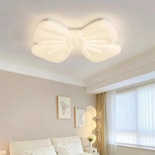 White butterfly knot shaped flush mount ceiling light in a bedroom