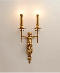 Gold wall sconce with a classical design on a light gray background