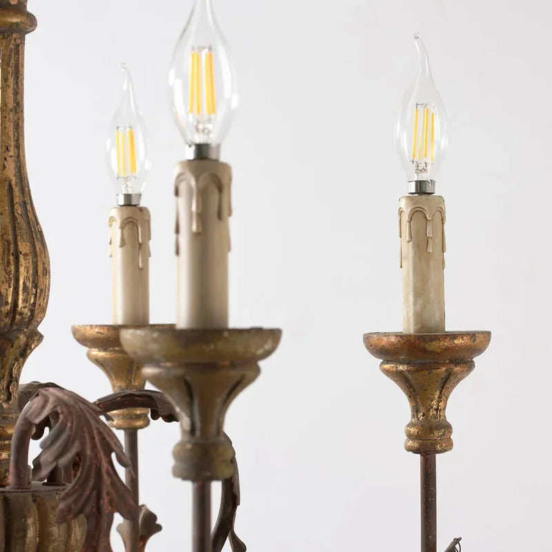 Close-up of a chandelier with three lit light bulbs on a white background