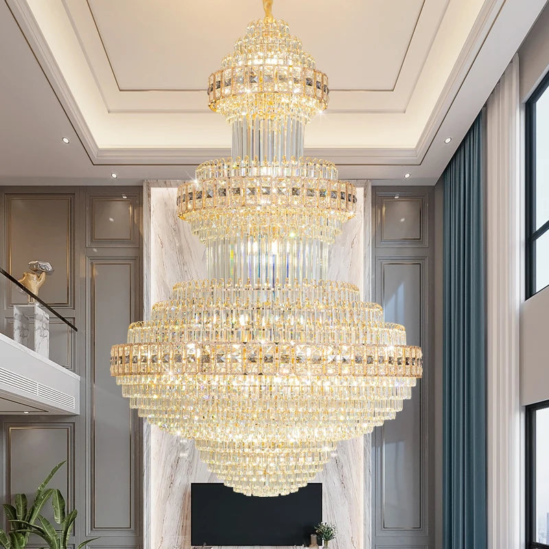Close-up of the gold finish and faceted crystal details on a tiered waterfall chandelier.